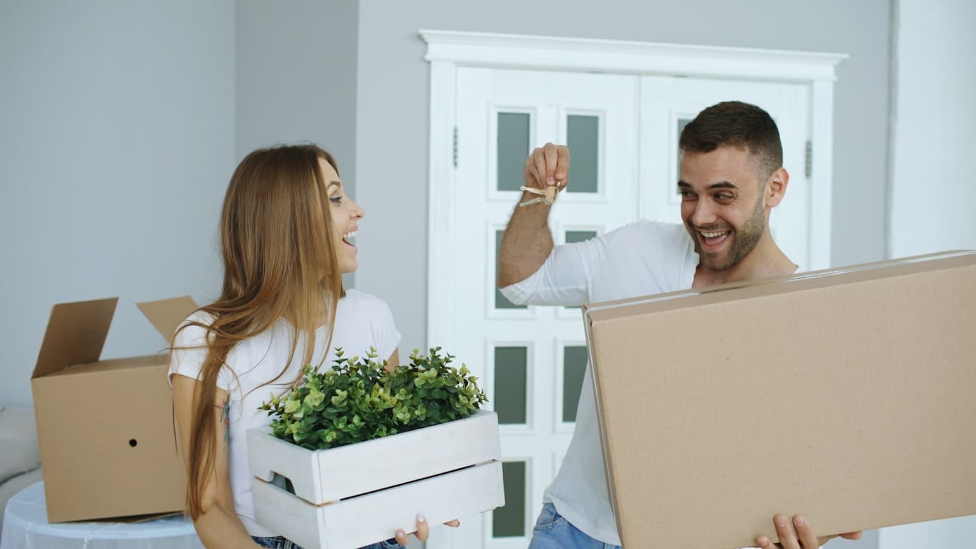 A couple holding keys on move-in day